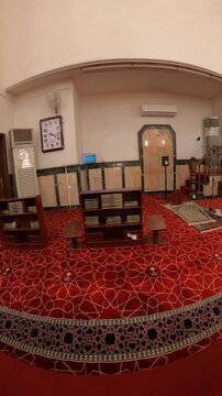 Panning view inside the historic Al-Ijabah Mosque in Medina, showing the prayer hall and minbar.