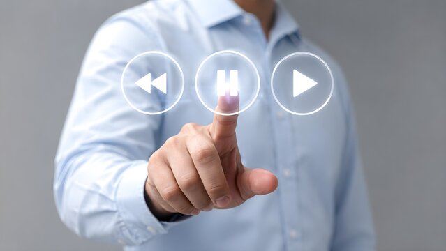 Fingers touching glowing virtual media player icons for play, pause, and rewind functions on a gray background, representing digital control and technology