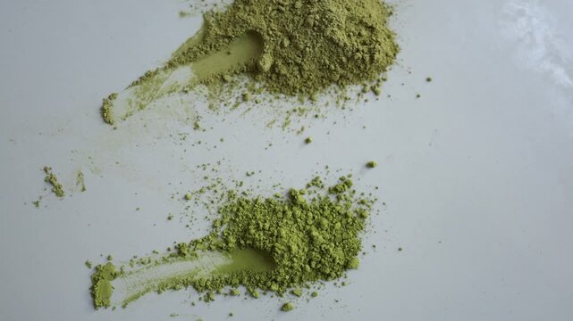 Two piles of matcha powder show color differences between vivid green quality tea and dull swamp toned powder helping buyers recognize freshness when choosing matcha teas

