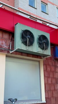 Close-up view of industrial cooling fans mounted at the top, ensuring optimal airflow in storage space. Installing industrial cooling fans above storage area enhances airflow and climate control