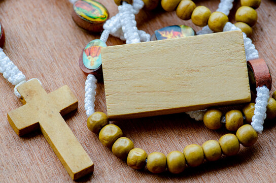 Top view of wooden Holy Rosary on wooden table with customizable space for text. Religion concept.