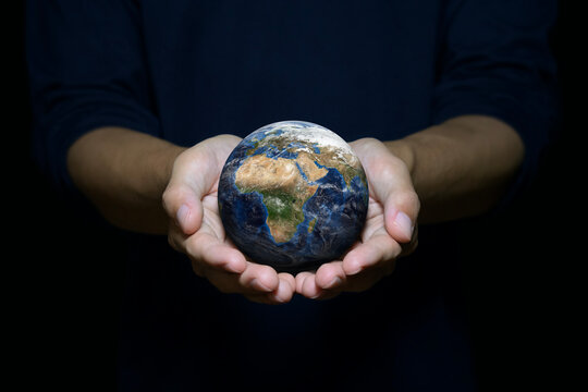 Business sustainability and environmental responsibility concept, hands holding planet Earth, representing sustainable business, ESG, and commitment to protecting the environment.