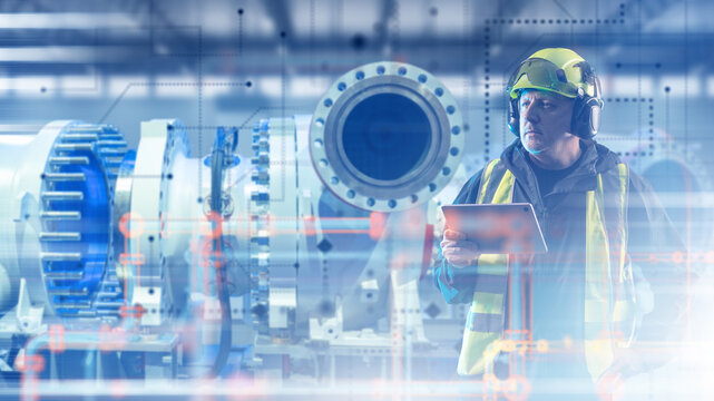 Industrial equipment inspection, engineer uses a tablet to monitor large pipeline machinery, mechanical systems and digital process control at a factory.