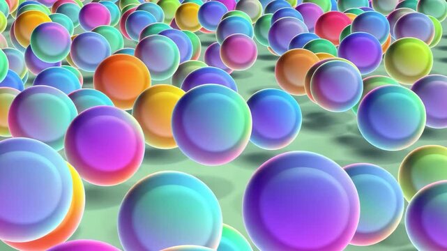 Spheres gently bouncing in a colorful patterned field during a soft light transition