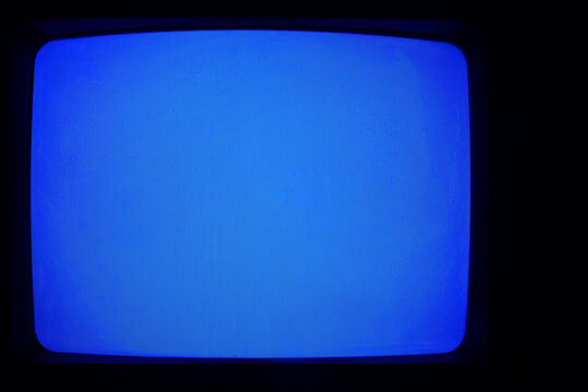 Old retro aged historical tube tv television light blue screen, vintage screen with noise no signal isolated on black dark darkness background backdrop Empty template blank Mock up mockup chroma key