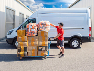 Parcel delivery, last mile logistics. Courier transports packages on a cart beside a cargo van, preparing customer orders for distribution and delivery. © Grispb