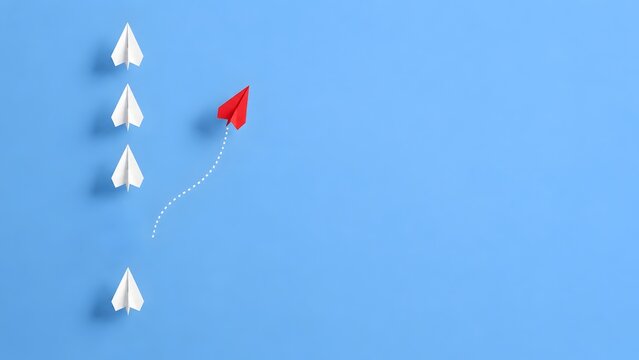Red Paper Plane Changing Trajectory and Standing Out from the Crowd on Blue Background