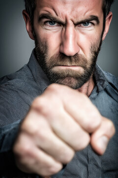 people of ai, angry model showing fist towards camera with an intense scowl, photorealistic