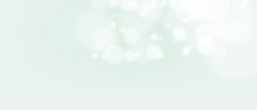 Bokeh background Soft white glowing circles on a pale green with bright