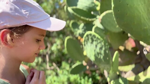  Young Girl Touching Prickly Pear Cactus Outdoor Horizontal Shot