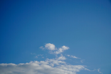 Fototapeta premium Minimal blue sky background with light white clouds horizontal