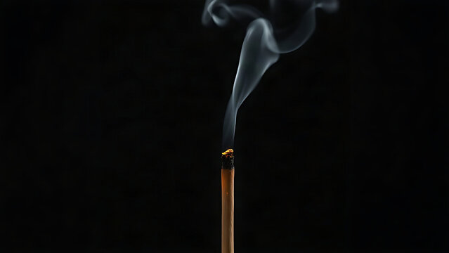 A burning moxa stick with curling smoke, glowing ember against a dark background.