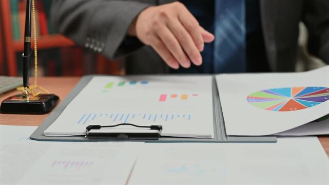 Executive performs detailed financial analysis reviewing business document, executing market analysis intended support corporate investment decision making context featuring investment analysis.