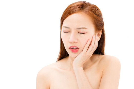 Woman suffering from toothache and holding cheek