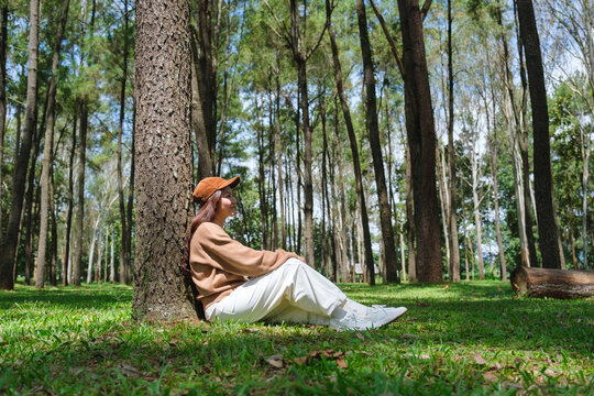 Portrait image of a woman sitting and relaxing in the park