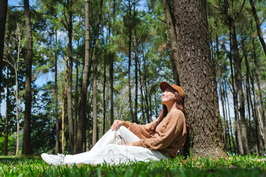 Portrait image of a woman sitting and relaxing in the park