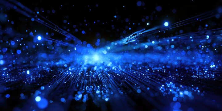 A vibrant, glowing blue light explodes amidst a field of tiny, sparkling particles
