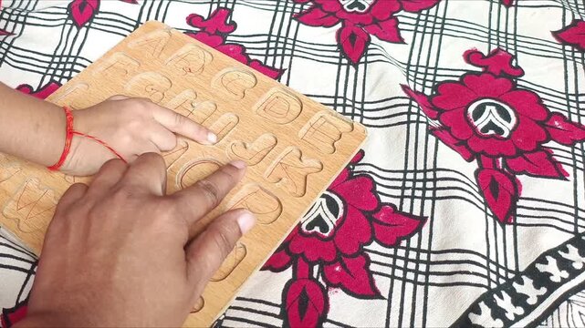 Children Learning English Alphabets Using Wooden Tracing Board at Home