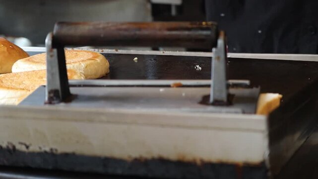 Placing Sliced Bread onto Hot Griddle in Kitchen for Grilled Cheese Sandwich