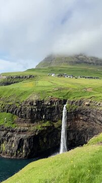 M&uacute;lafossur Waterfall at Faroe Islands in Summer. Vertical Footage