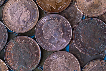 British pennies and two pence featuring Queen Elizabeth II profile portrait. British copper coins. Great Britain national currency. © Sergii