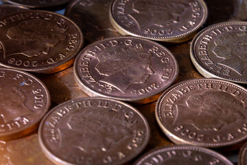 British pennies and two pence featuring Queen Elizabeth II profile portrait. British copper coins. Great Britain national currency. © Sergii