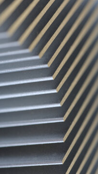 Abstract geometric lines texture of a metallic cooling fin radiator, mobile vertical portrait orientation.