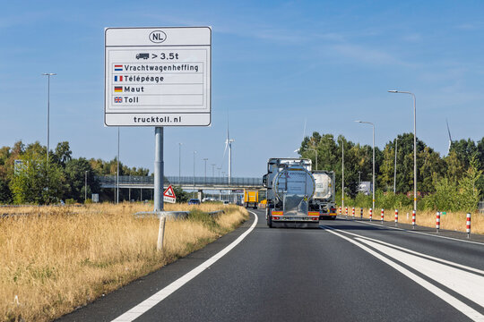 Netherlands, 14 August 2026. Highway traffic sign indicating Dutch truck toll system for heavy goods vehicles over 3.5 tons with tanker truck on road.