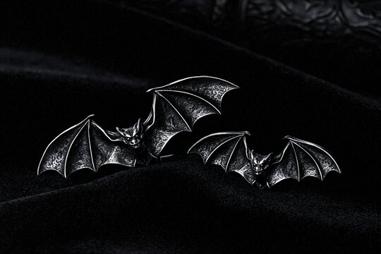 Gothic silver bat earrings on black velvet dark moody jewelry display
