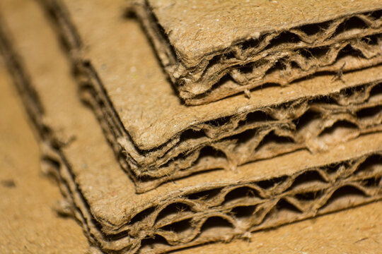 Close-up shot of layered corrugated cardboard sheets showing texture and structural design