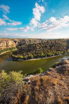 Hoces del Duraton canyon landscape view, Segovia Spain. Limestone cliffs and river bend under blue sky. High quality photo