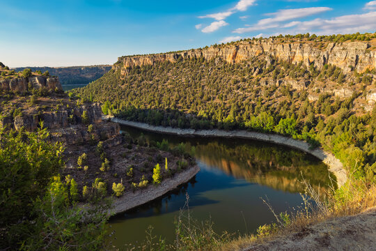 Hoces del Duraton canyon landscape view, Segovia Spain. Limestone cliffs and river bend under blue sky. High quality photo