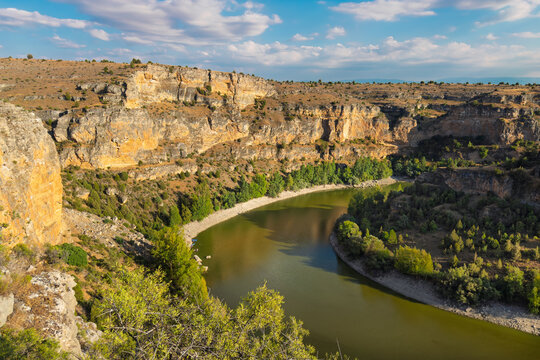 Hoces del Duraton canyon landscape view, Segovia Spain. Limestone cliffs and river bend under blue sky. High quality photo