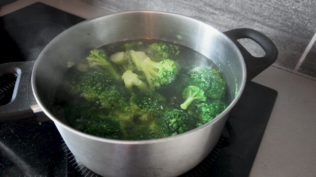 Fresh broccoli florets boiling in a pot of water