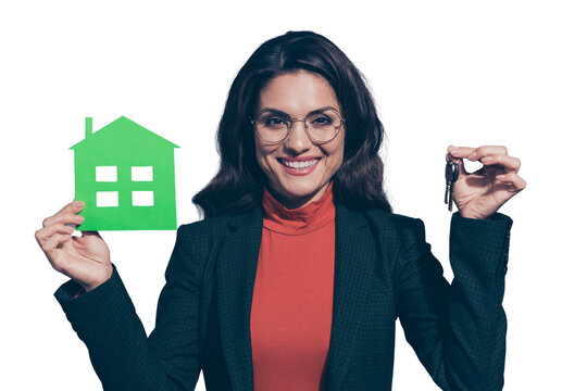Welcome to new flat! Portrait of her she nice lovely elegant chic classy attractive cheerful wavy-haired lady holding in hands green home giving key isolated over gray pastel background