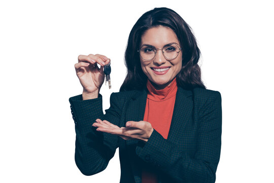 Welcome to new flat! Portrait of her she nice lovely elegant chic attractive cheerful wavy-haired lady holding in hands showing giving key car sales manager isolated over gray pastel background