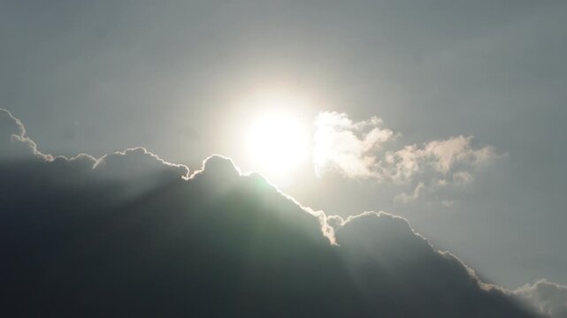 Bright sunlight breaking through dark dramatic clouds