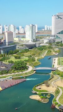 Aerial view from a drone. Vertical video of Songdo Central Park, Incheon City, South Korea