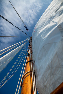 Vertical View of Wooden Main Mast, Traditional Sailboat Rigging and Sailcloth Detail from Deck