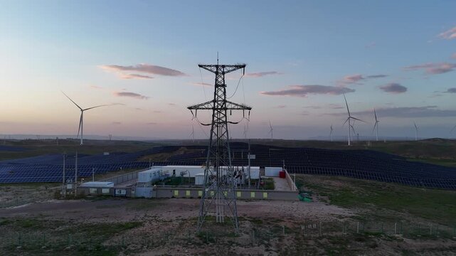 wind turbines and high voltage transmission tower in renewable energy field