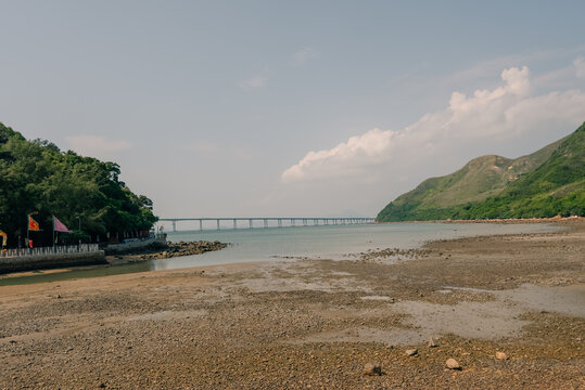 Muddy intertidal flats exposed at low tide near Tai O on Lantau Island, Hong Kong, revealing the coastal landscape and tidal ecosystem of this historic fishing village Hong Kong, China - 30 August 202