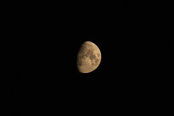 Waxing gibbous moon showing detailed lunar craters against black sky © AdobeTim82