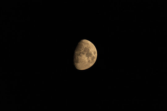 Waxing gibbous moon showing detailed lunar craters against black sky
