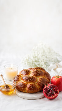 Braided challah beside apples honey, pomegranate along lower edge, rosh hashanah menu background with open copy space for holiday text
