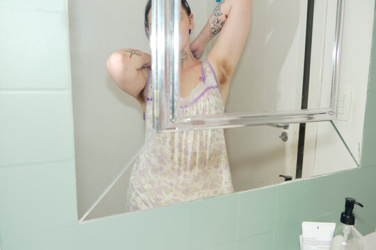 Confident alternative person getting ready for bed in the bathroom