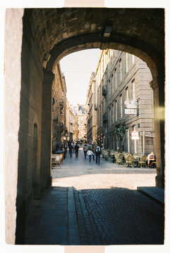 Old stone archway leading to a city street
