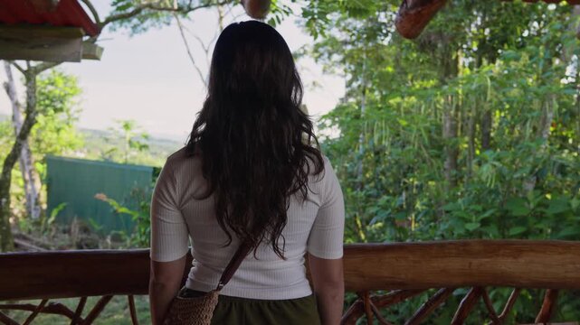 Tourist admiring lush green jungle view from a balcony