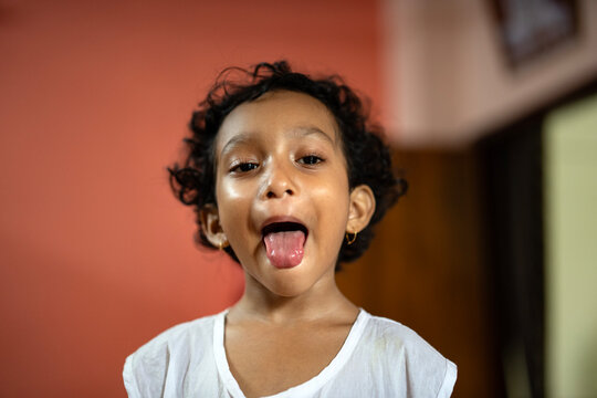 Little girl portrait making fun and showing tongue