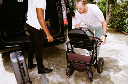 Man helps with stroller and luggage at the car