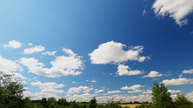Fast Moving Summer Clouds Across Clear Blue Sky With Low Horizon, Natural Weather and Nature Background Timelapse